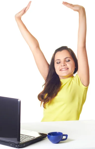 Attractive smiling girl in yellow shirt sitting at a table with — Stock Photo, Image