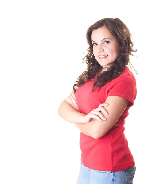 Attractive smiling girl in a red shirt and blue jeans standing w — Stock Photo, Image