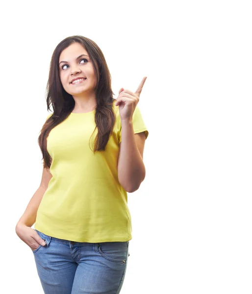 Jolie jeune femme souriante dans une chemise jaune montre la gauche — Photo