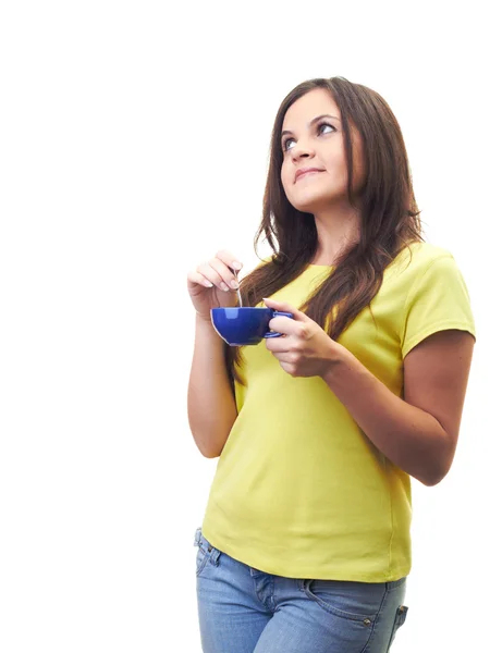 Attractive young woman in a yellow shirt holding a blue cup with — Stock Photo, Image