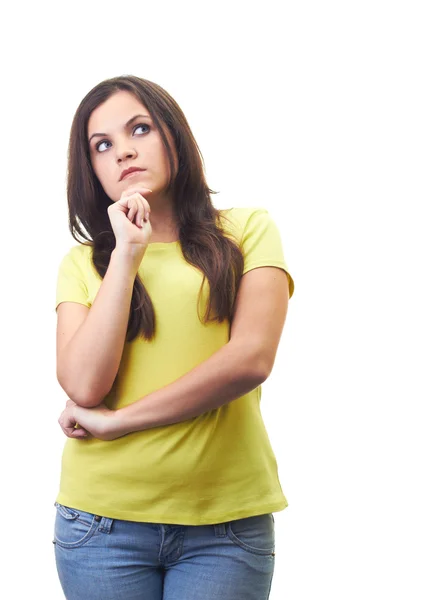 Attractive young woman in a yellow shirt dreams and looks the up — Stock Photo, Image