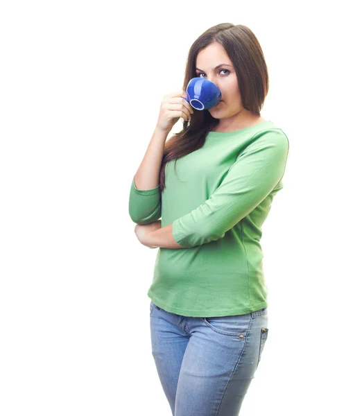 Attractive smiling young woman in a green shirt, drinking from a — Stock Photo, Image
