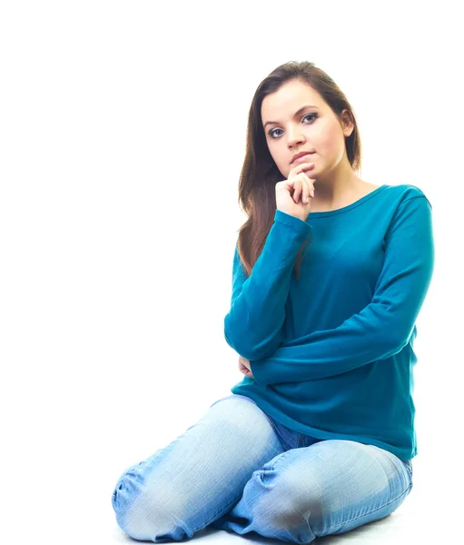 Attractive smiling young woman in a blue shirt sitting on the fl — Stock Photo, Image