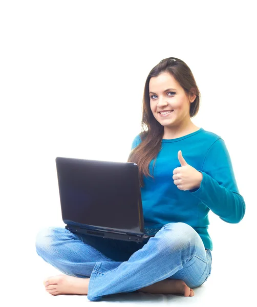 Attractive smiling young woman in a blue shirt sitting on the fl — Stock Photo, Image