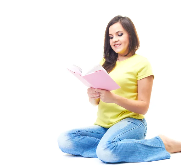 Attractive smiling young woman in a yellow shirt sitting on the — Stock Photo, Image