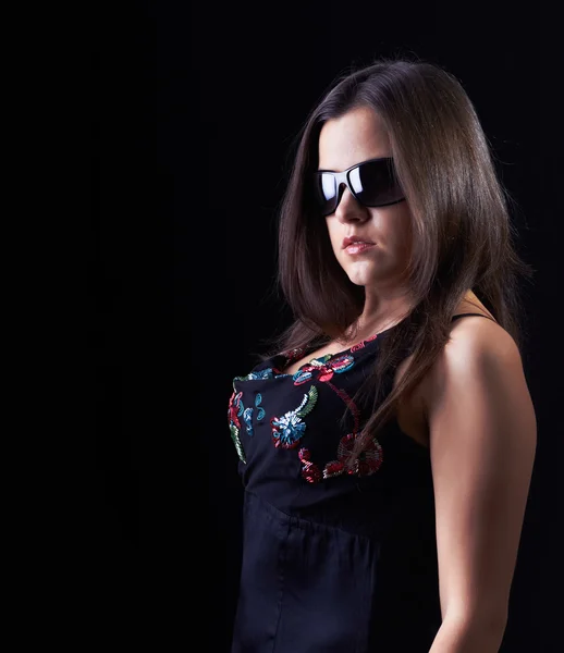 Attractive young woman in a black blouse and glasses. — Stock Photo, Image