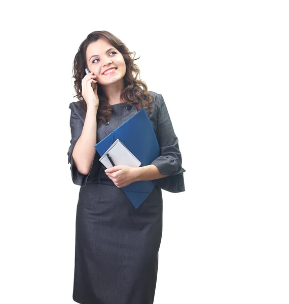 Attractive smiling young woman in a gray business dress holding — Stock Photo, Image