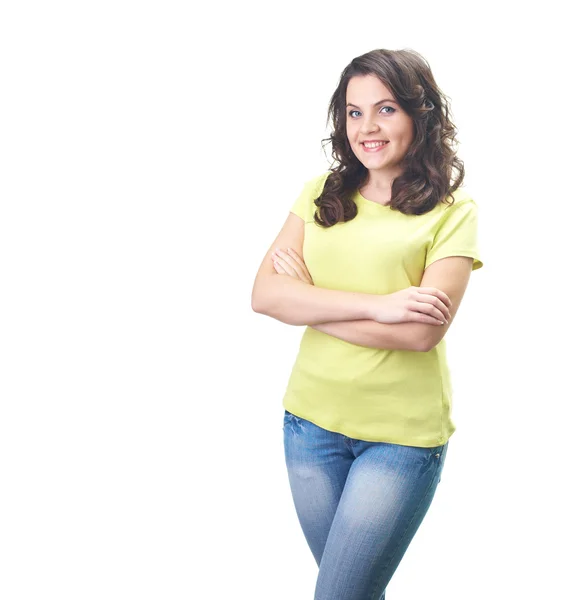 Attractive smiling young woman in a yellow shirt standing with h — Stock Photo, Image