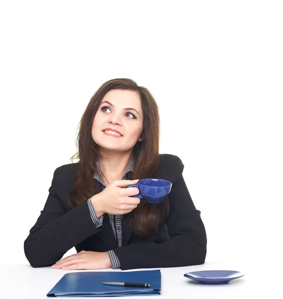 Attractive smiling young woman in black jacket sitting at the ta — Stock Photo, Image