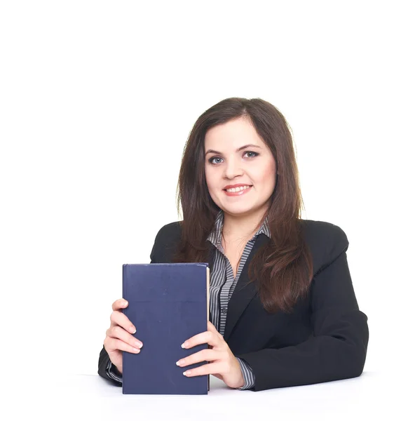 Attractive smiling young woman in black jacket sitting at the ta — Stock Photo, Image