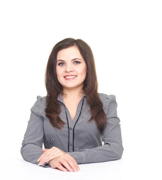 Attractive smiling young woman in a gray blouse sitting at the t — Stock Photo, Image