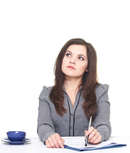 Attractive young woman in a gray blouse sitting at the table thi — Stock Photo, Image