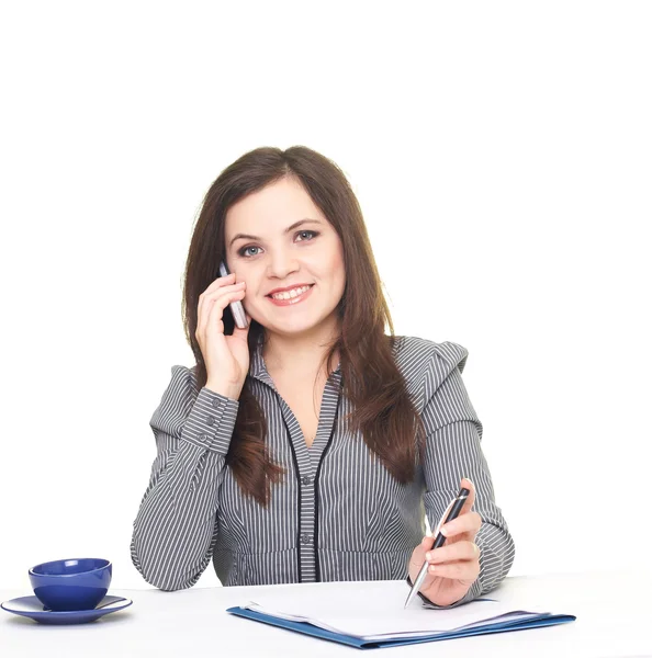 Attractive smiling young woman in a gray blouse sitting at the t — Stock Photo, Image