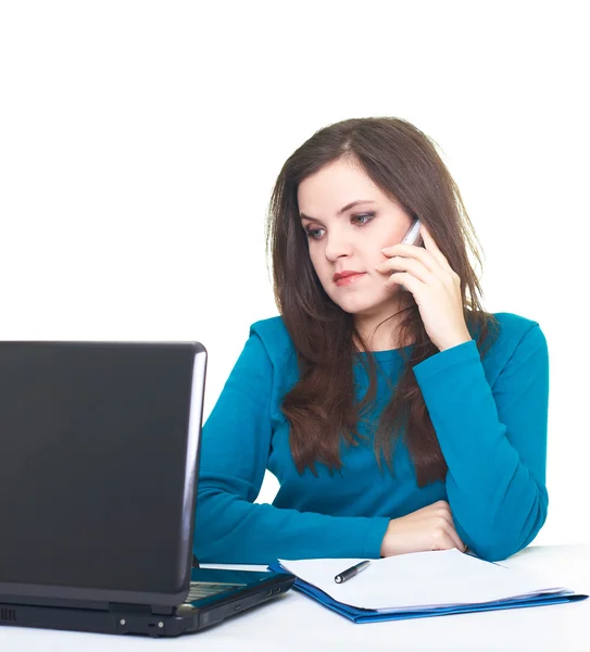 Attractive young woman in blue shirt working on laptop and talki — Stock Photo, Image