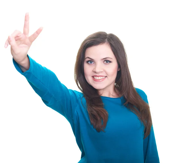 Aantrekkelijke jonge vrouw in een blauw shirt glimlachend toont haar juiste h — Stockfoto