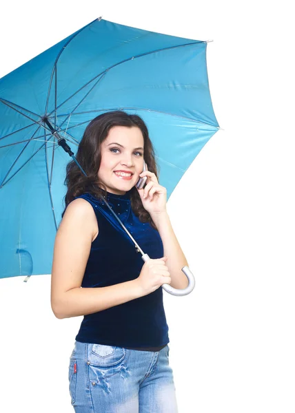 Attractive smiling young woman in a blue shirt talking on a mobi — Stock Photo, Image