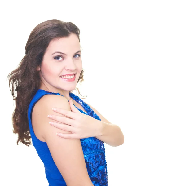 Attractive smiling young woman in a blue shiny dress hugs her ha — Stock Photo, Image