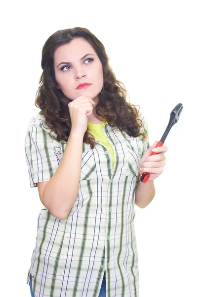 Attraktive junge Frau im karierten Hemd mit einem Schraubenschlüssel und — Stockfoto
