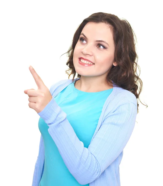 Attractive smiling young woman in a blue shirt shows a finger in — Stock Photo, Image