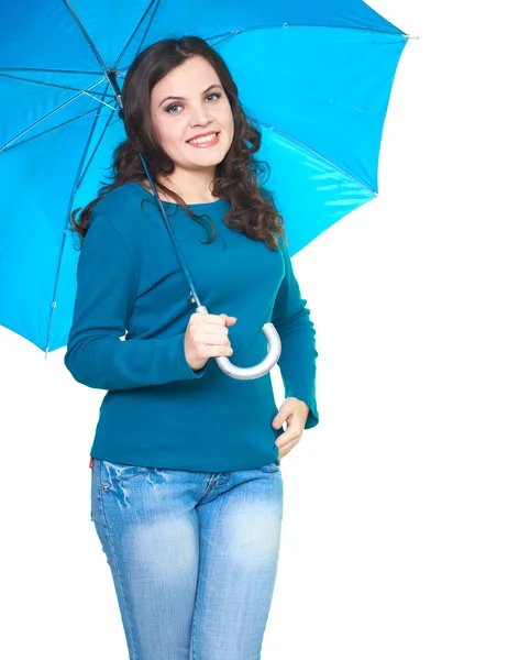 Attractive smiling young woman in a blue shirt standing under a — Stock Photo, Image