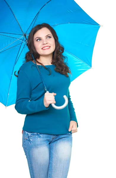 Attractive smiling young woman in a blue shirt standing under a — Stock Photo, Image