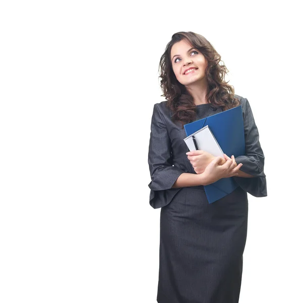 Attractive smiling young woman in a gray business dress holding Royalty Free Stock Images