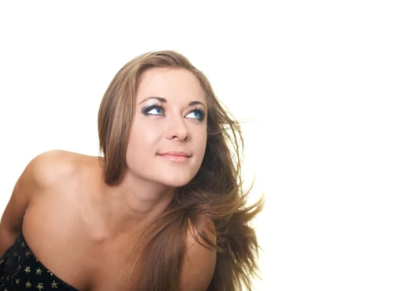 Attractive young woman in a black dress looks into the upper-lef — Stock Photo, Image