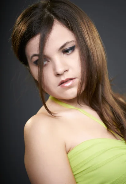 Attractive young woman in a green dress. Look in the lower right — Stock Photo, Image