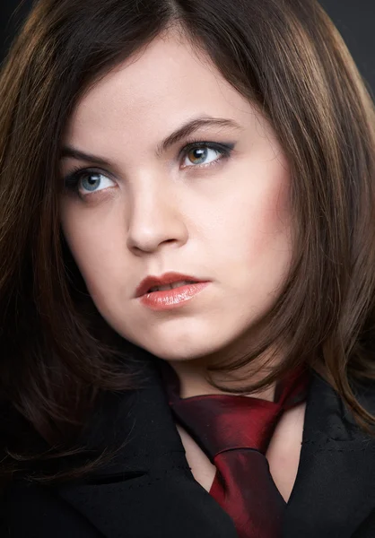 Portrait of attractive young woman in a black suit and tie. Woma — Stock Photo, Image