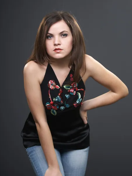 Attractive young woman in a black blouse