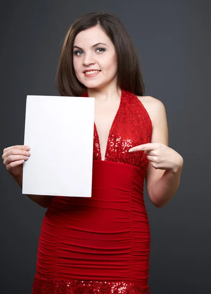 Attractive young woman in a red dress. Woman holds a poster in h — Stock Photo, Image