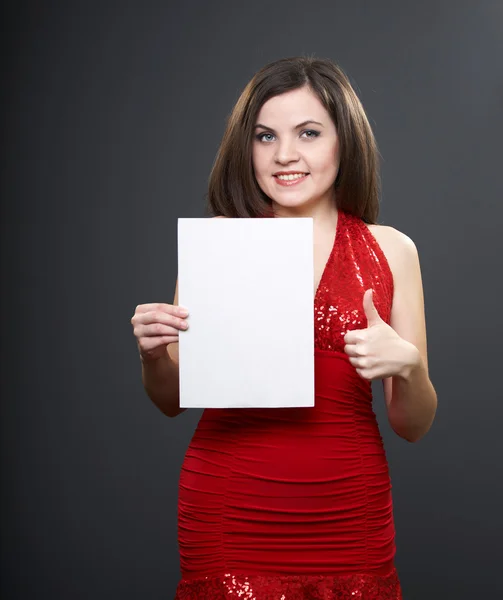 Attractive young woman in a red dress. Woman holds a poster in h — Stock Photo, Image