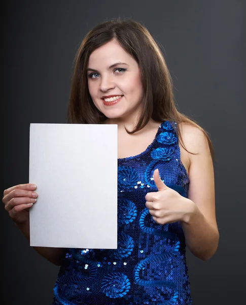 Happy young woman in a blue dress. Woman holds a poster in her r — Stock Photo, Image