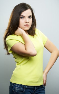 Attractive young woman in a yellow shirt and jeans. Woman hugs h