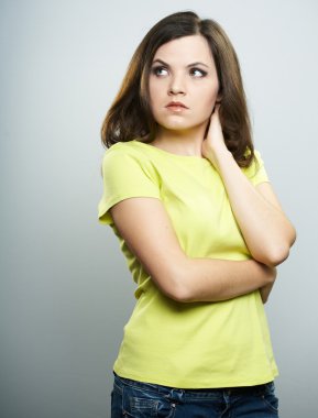 Attractive young woman in a yellow shirt and jeans. Woman hugs h