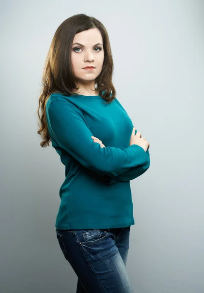 Attractive young woman in a blue shirt and jeans. Woman standing — Stock Photo, Image
