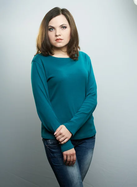 Attractive young woman in a blue shirt and jeans. — Stock Photo, Image