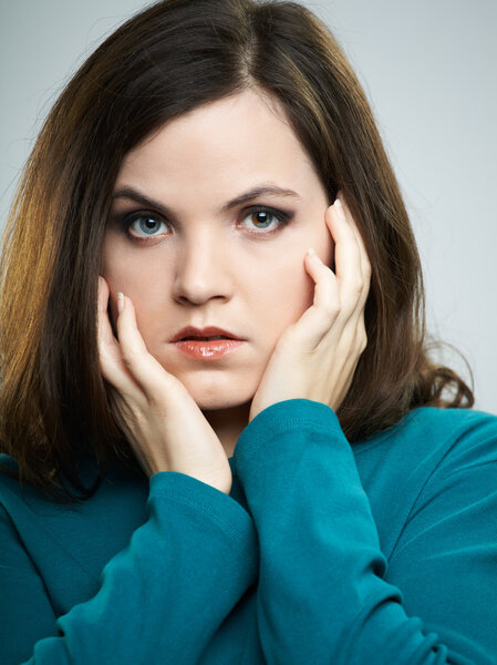 Portrait of attractive young woman in a blue shirt. Woman hugs h