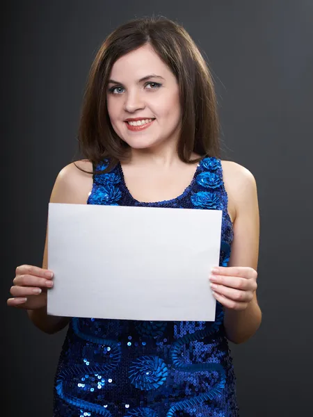 Happy young woman in shiny blue dress. Woman holds a poster. — Stock Photo, Image