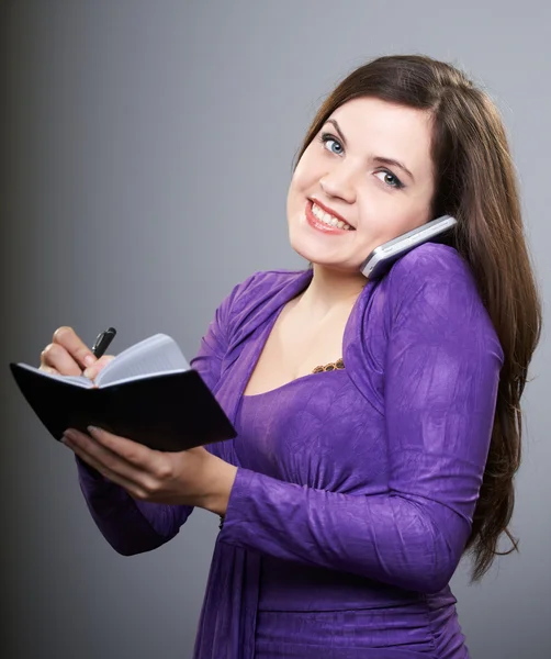 Attractive young woman in a lilac dress. Woman talking on mobile — Stock Photo, Image