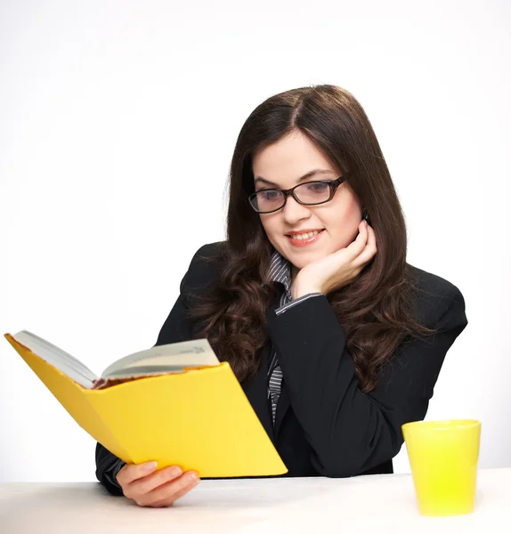 Attractive young woman in a black jacket and glasses sitting at — Stock Photo, Image