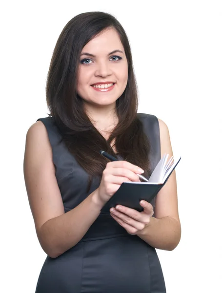 Attractive young woman in a gray business dress. Woman holds a n — Stock Photo, Image