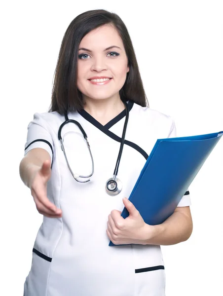 Attractive young nurse. Woman holds a blue folder and give a han — Stock Photo, Image