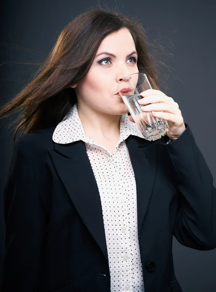 Attractive young woman in a black jacket. Woman drinking mineral — Stock Photo, Image