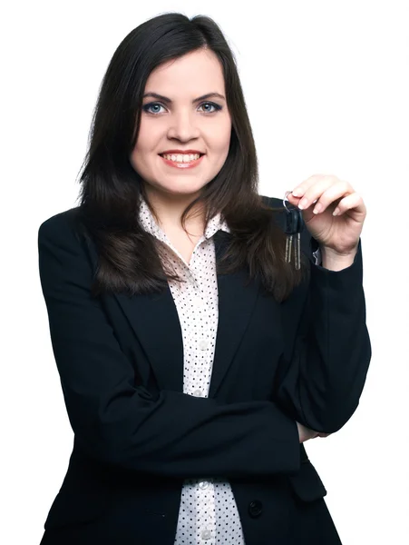 Attractive young woman in a black jacket. Woman holds the keys. — Stock Photo, Image