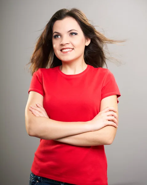 Attractive young woman in a red shirt. Woman standing with folde — Stock Photo, Image