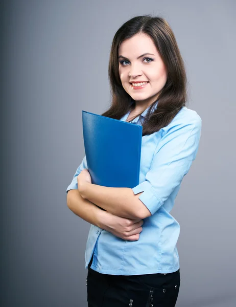 Attractive young woman in a blue blouse. Woman holds a blue fold — Stock Photo, Image