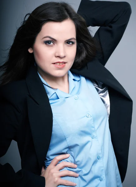 Una joven atractiva con una chaqueta negra. Cabello en movimiento . —  Fotos de Stock