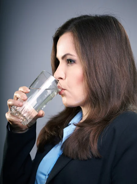 Attraktive junge Frau in schwarzer Jacke. Frau trinkt Mineralwasser — Stockfoto