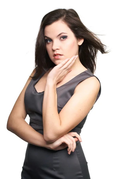 Attractive young woman in a gray business dress. Hair in motion. Stock Image